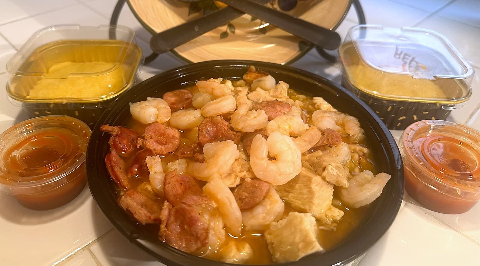 22 oz bowl of three meat jambalaya with chicken, sausage and shrimp, served with cornbread and sauces
